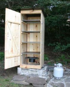 a wooden cabinet sitting in the middle of a field