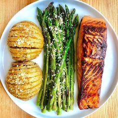 salmon, asparagus and potatoes on a white plate