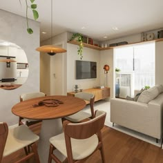 a living room filled with furniture and a flat screen tv on top of a wooden table