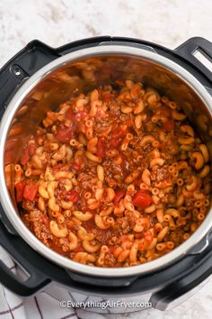 an overhead view of a crock pot filled with chili macaroni and cheese