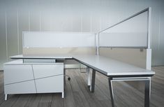 an office desk with two white cabinets on each side