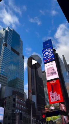 a city street filled with lots of tall buildings and billboards on the side of it