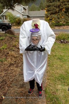 a man in a costume is standing on the sidewalk