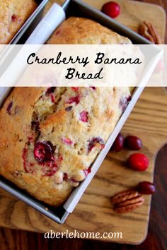 cranberry banana bread in a loaf pan on a cutting board with pecans