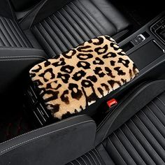 the interior of a car with a leopard print seat cover