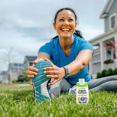 a woman sitting in the grass with a bottle of organic nutrition milk next to her