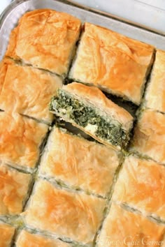 spinach and cheese puff pastry in a baking pan with a bite taken out of it