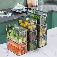 several containers filled with vegetables sitting on top of a counter