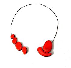 a red necklace on a white background