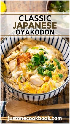 a bowl filled with chicken and vegetables on top of a wooden table