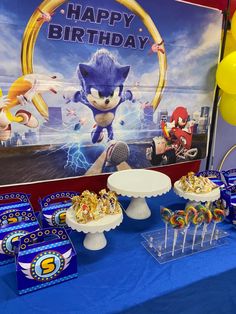 a sonic the hedgehog birthday party with desserts and snacks on a blue tablecloth