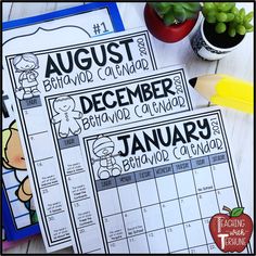 two calendars with the words august and december on them next to a potted plant