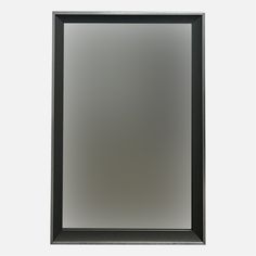 a black framed mirror sitting on top of a white wall