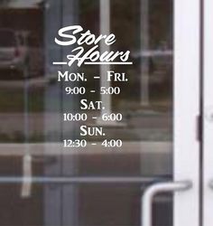 the store hours sign is on the glass door