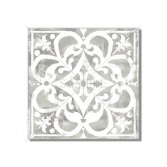 a white tile with an ornate design on it