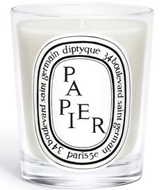 a candle that is sitting in front of a white background with the words paper on it