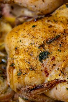 a close up of a chicken with herbs on it