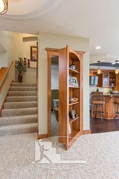 an open door leading to a kitchen and living room area with stairs in the background