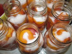 there are many jars filled with oranges and powdered sugar on the top one