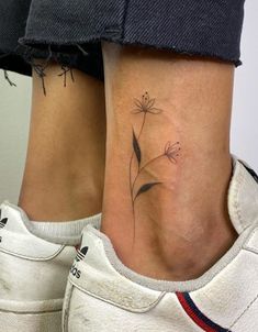 two women with tattoos on their legs and one has a flower tattoo on her leg