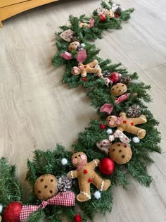 a christmas wreath with teddy bears and other decorations