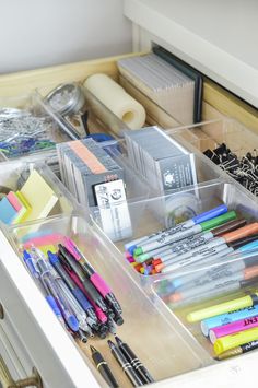 an organized drawer with pens, markers and other office supplies