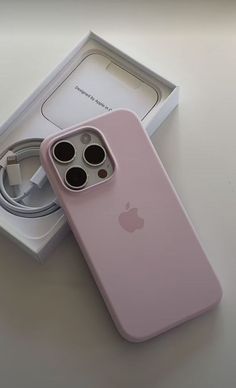 an iphone case sitting on top of a box next to a charger and cable