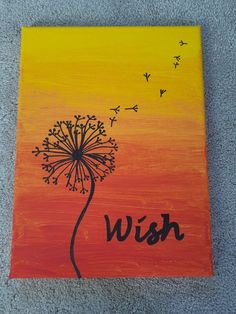 a dandelion with the word wish painted on it in black and orange colors