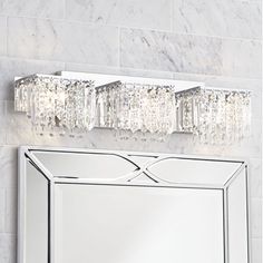 a bathroom vanity with a mirror and lights above it