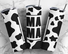 three black and white cow print tumblers with the word mam on them, sitting next to each other