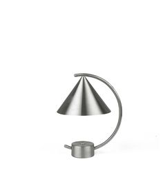 a lamp that is on top of a white surface with a metal holder underneath it