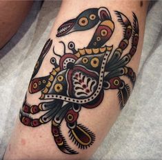 a colorful tattoo on the arm of a person with an intricate bird and flower design