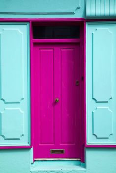 a pink and blue door with two windows