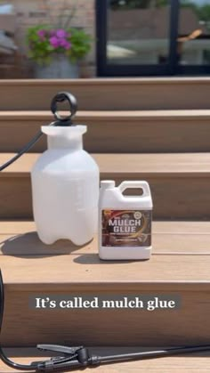 a white jug sitting on top of a wooden bench next to a bottle of glue