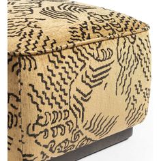 an upholstered footstool with black and tan designs on it's sides