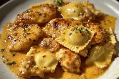 a white plate topped with ravioli and meat