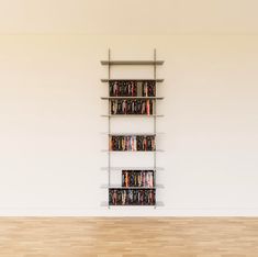 an empty room with a book shelf filled with books and dvds on it's sides