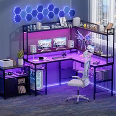 a computer desk with purple lighting in an office space next to a chair and window