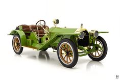 an old model green car on a white background