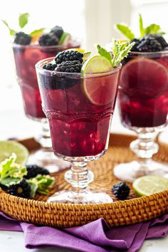 blackberry sangria in glasses with limes and blackberries on the rim text reads blackberry sangria