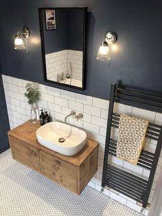 a bathroom with a sink, mirror and towel rack on the wall next to it