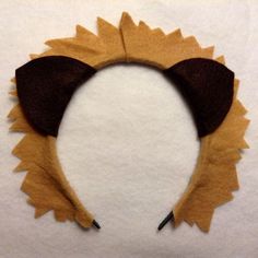 a cat ears headband made out of felt on top of a sheet of paper