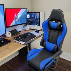 a computer desk with two monitors and a keyboard on it, along with a gaming chair