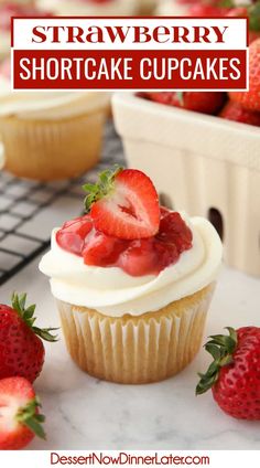 strawberry shortcake cupcakes with white frosting and fresh strawberries on top