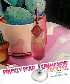 the prickly pear champagne cocktail is served in a pink wine goblet on a table with cacti