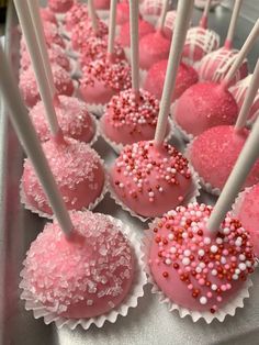 pink and white cake pops with sprinkles on them are ready to be eaten