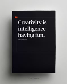 a black book with white lettering on the front and back cover that reads creativity is inteliligence having fun