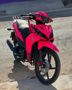 a red and black motorcycle parked on the street