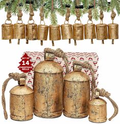 three old fashioned brass bells hanging from a christmas tree