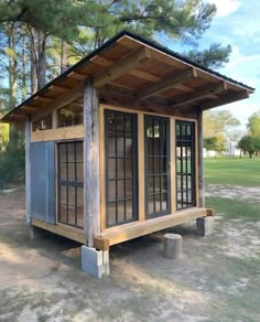 a small wooden structure with windows on the outside